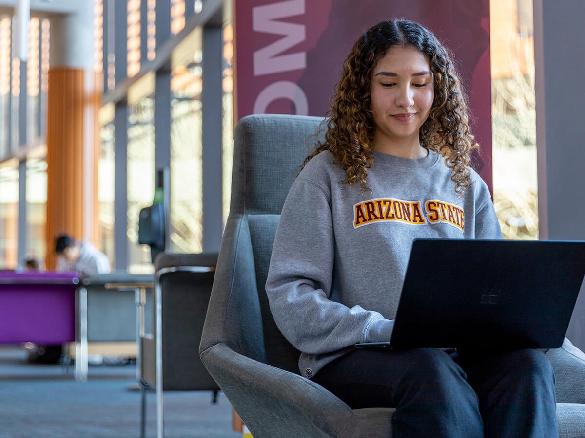 Student typing on a laptop