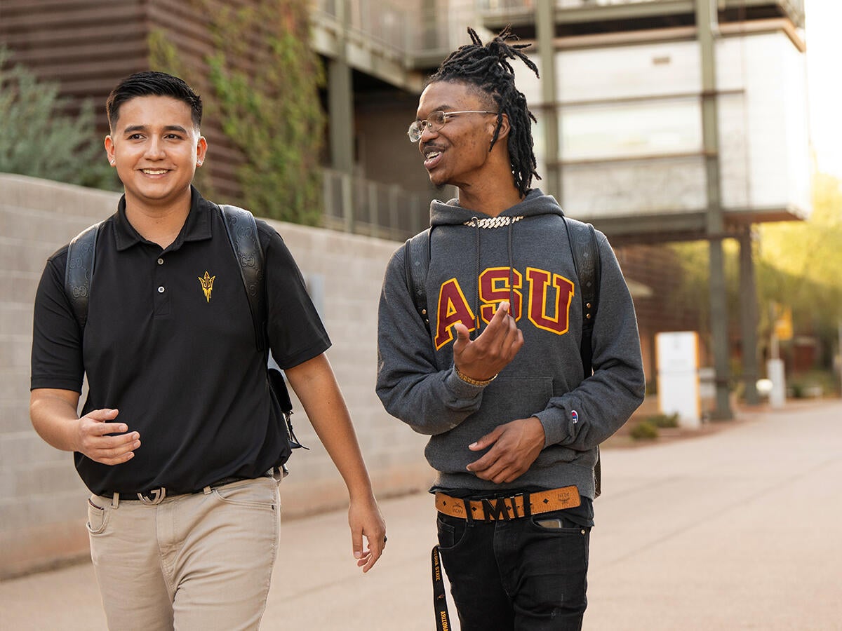 Two students walking on the polytechnic campus